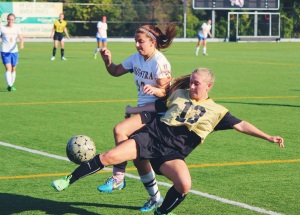 Left-forward, Vanessa Leigh, takes on Adelphi's number 13 in attempt to win the ball back for the Hofstra team. 