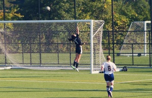 Hofstra Woman's Club Soccer Team goalie, Lia Rodriguez, jumps in the air to save a shot on goal. 